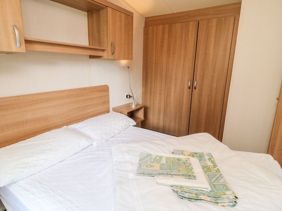 A bedroom with a bed and wardrobe at Brent Tor in Tavistock