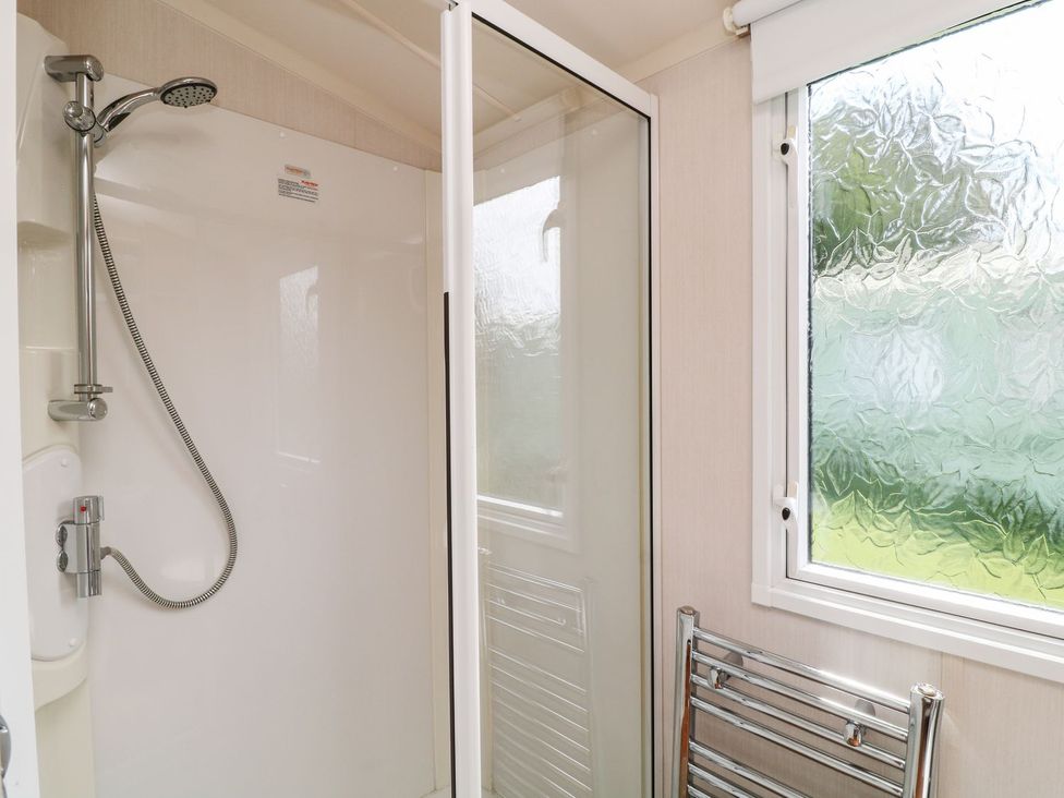 A shower with a glass enclosure and a towel rack at Brent Tor in Tavistock