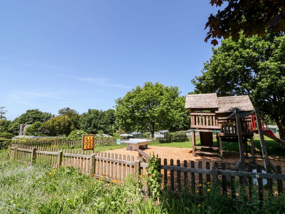 A playground with a climbing frame and slide at Brent Tor in Tavistock