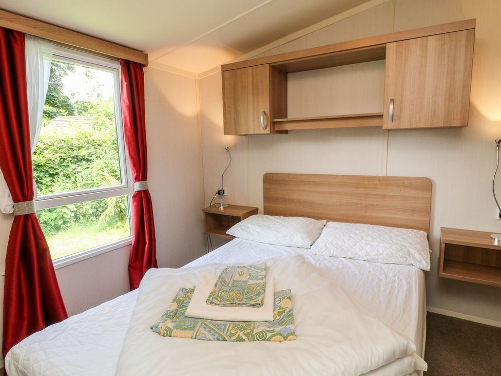 A bedroom with a bed and a window at Fur Tor in Tavistock