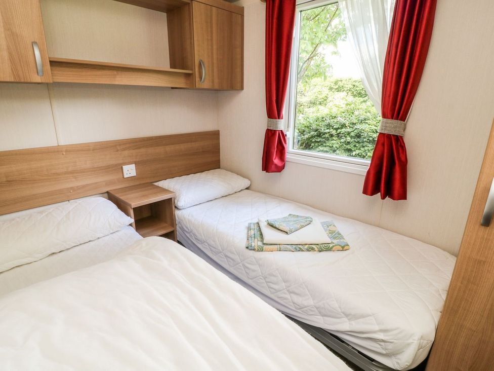 A bedroom with two beds and a window at Fur Tor in Tavistock
