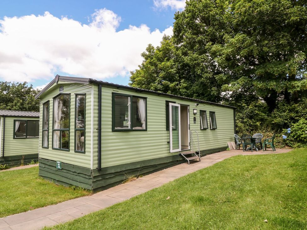 A holiday home with a patio and chairs at Great Mis Tour in Tavistock