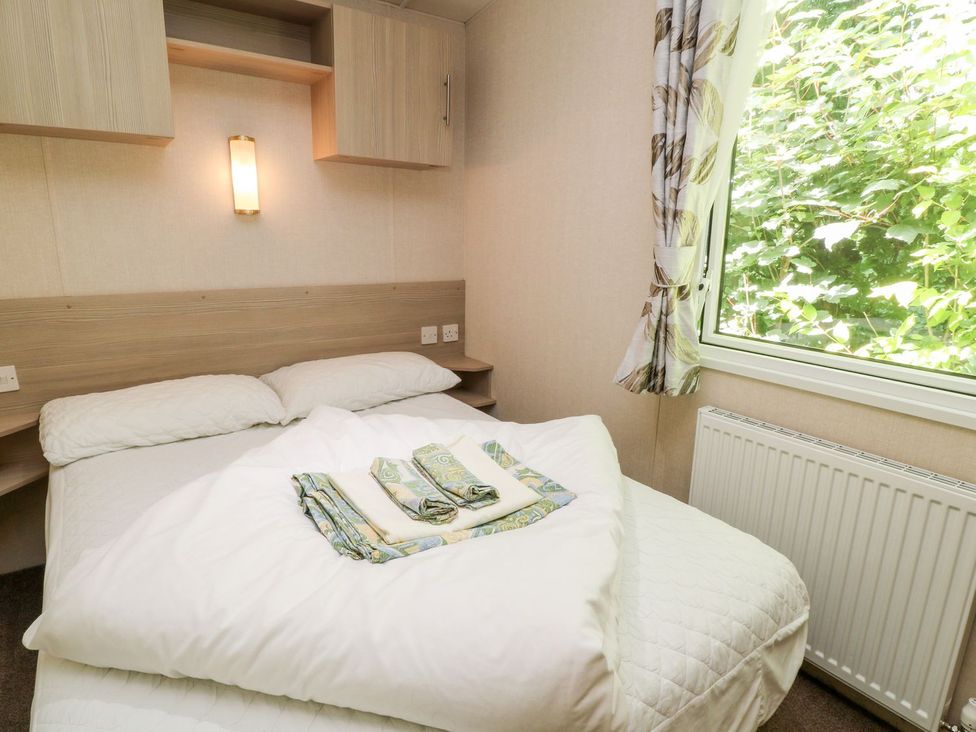 A bedroom with a bed and window at Great Mis Tour in Tavistock