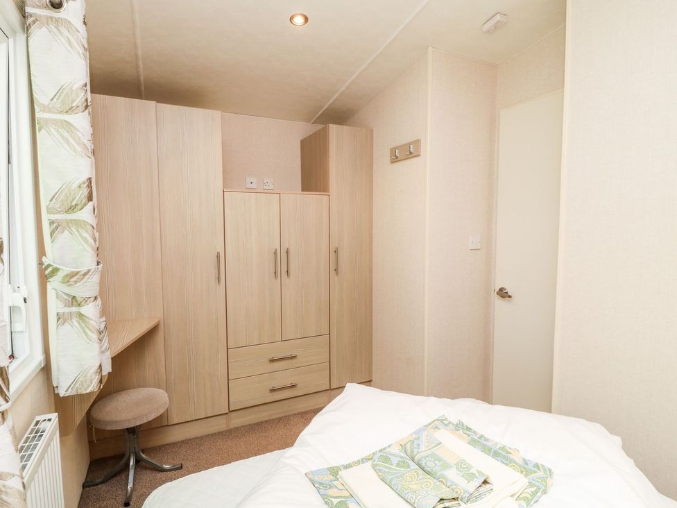A bedroom with a wardrobe and a bed at Great Mis Tour in Tavistock