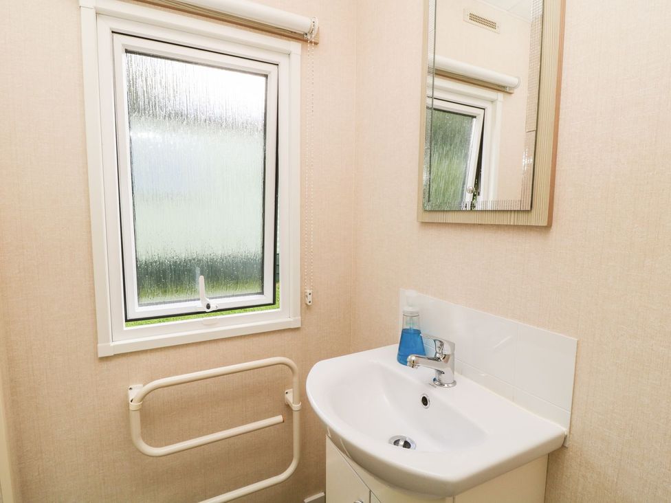 A bathroom with a sink and mirror at Great Mis Tour in Tavistock