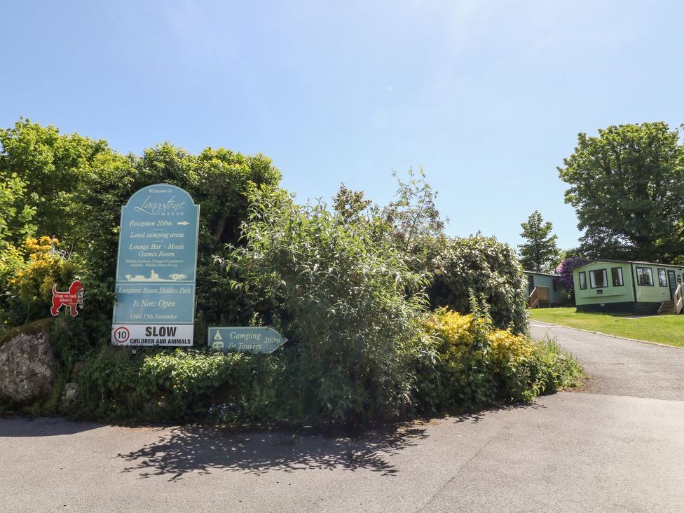 A sign indicating directions at the entrance of the site at Great Mis Tour in Tavistock