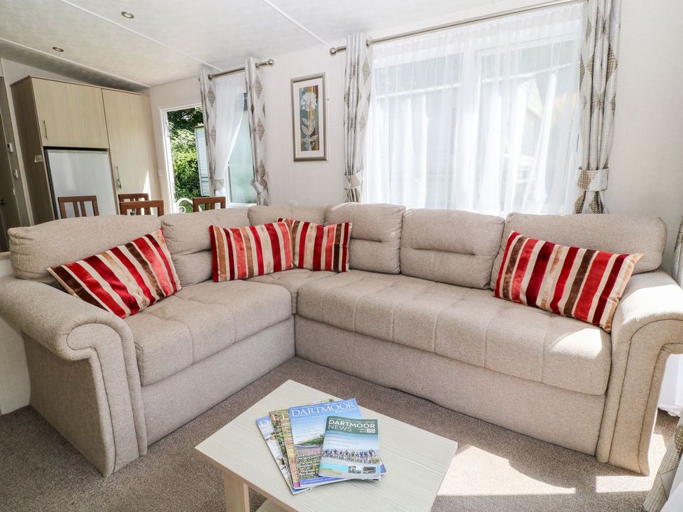 A living room with a sofa and table at Roos Tor in Tavistock