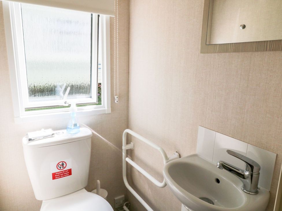 A bathroom with a toilet and sink at Roos Tor in Tavistock