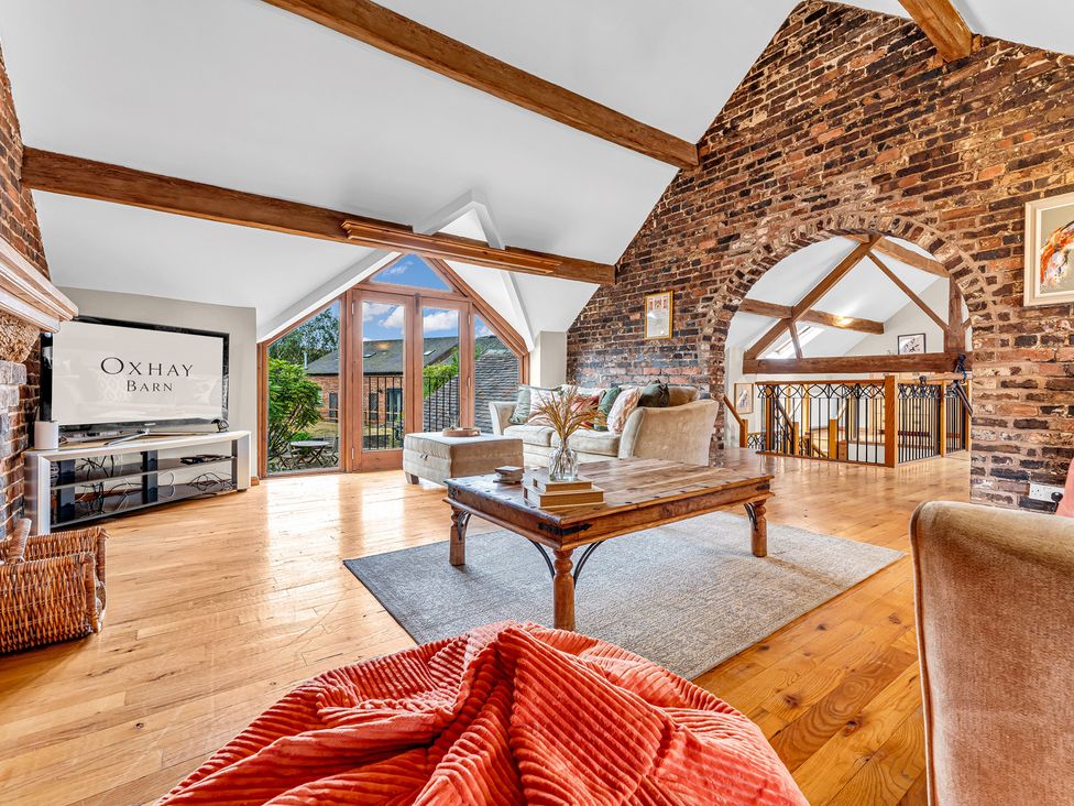 A living room with a sofa and coffee table at Oxhay Barn in Newcastle