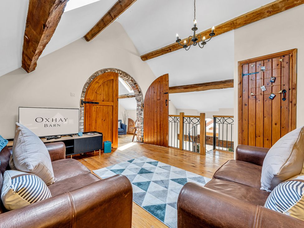 A snug with a sofa and rug at Oxhay Barn Newcastle