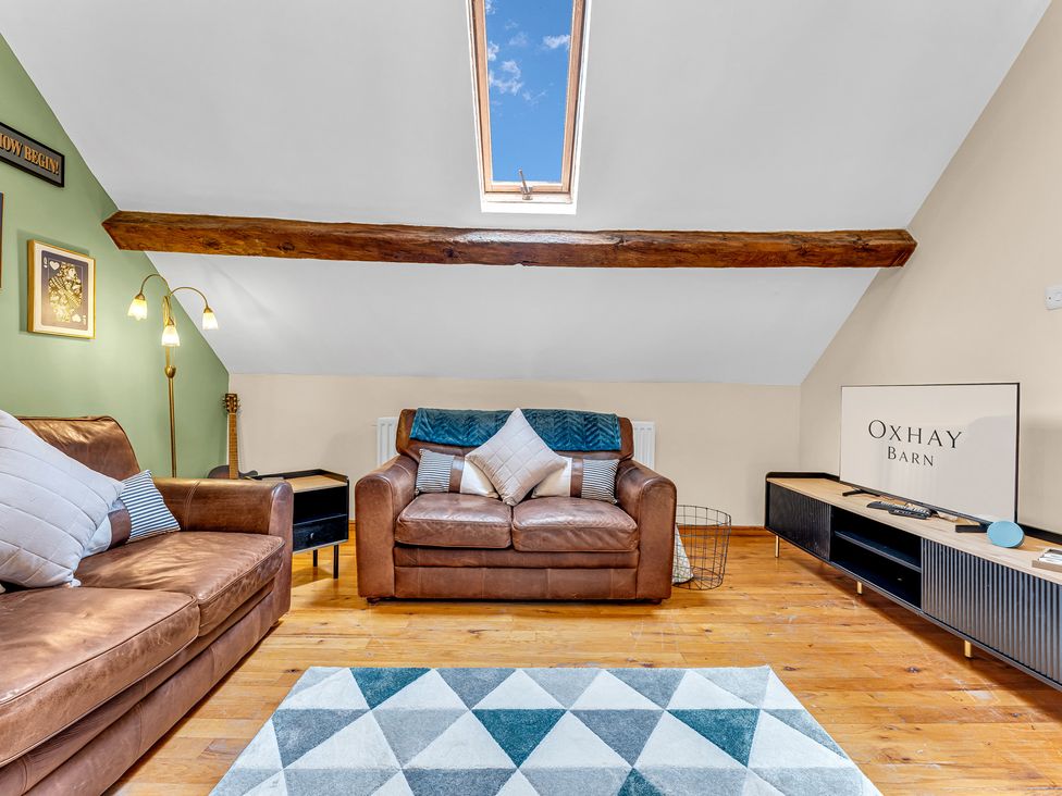 A living room with furniture and decor at Oxhay Barn Newcastle
