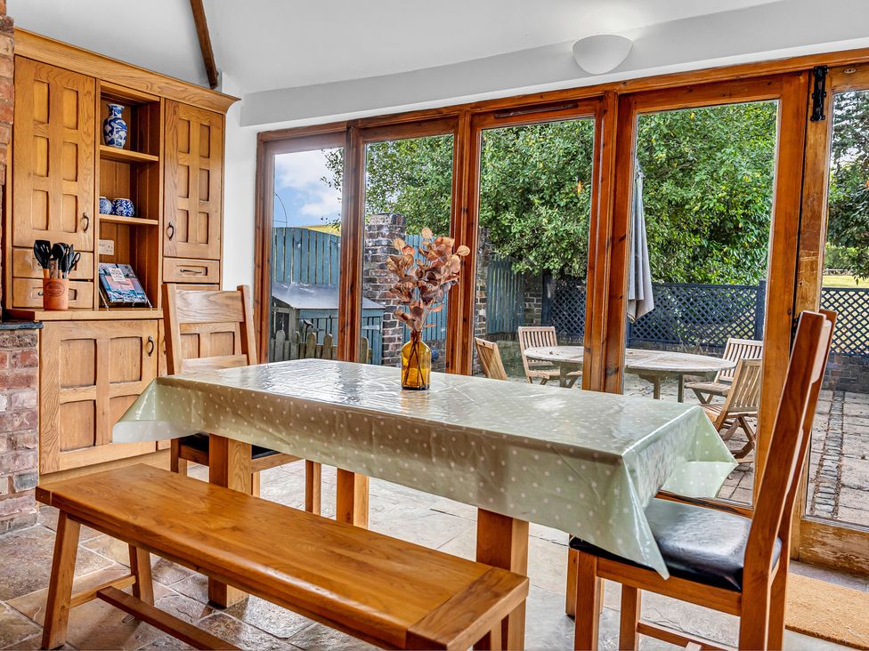 A dining room with a table and chairs at Oxhay Barn in Newcastle
