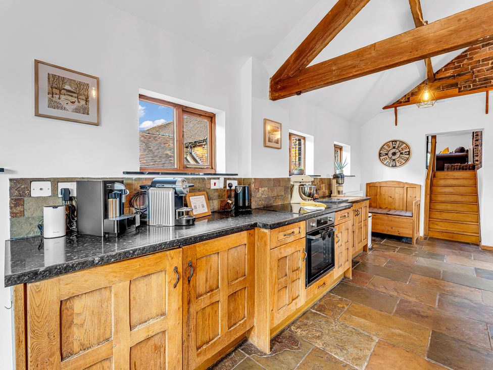A kitchen with wood furniture and appliances at Oxhay Barn Newcastle