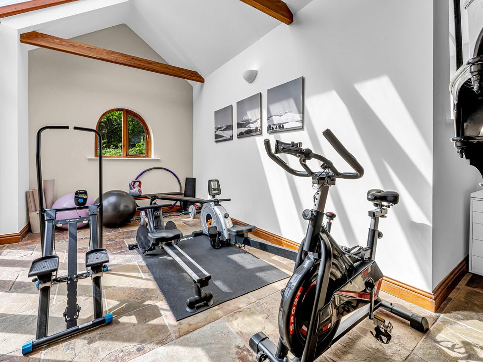 A gym with various exercise equipment at Oxhay Barn Newcastle