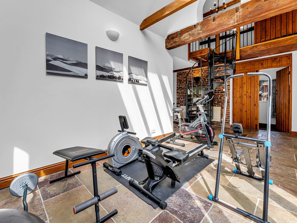 A gym with exercise equipment and artwork at Oxhay Barn Newcastle