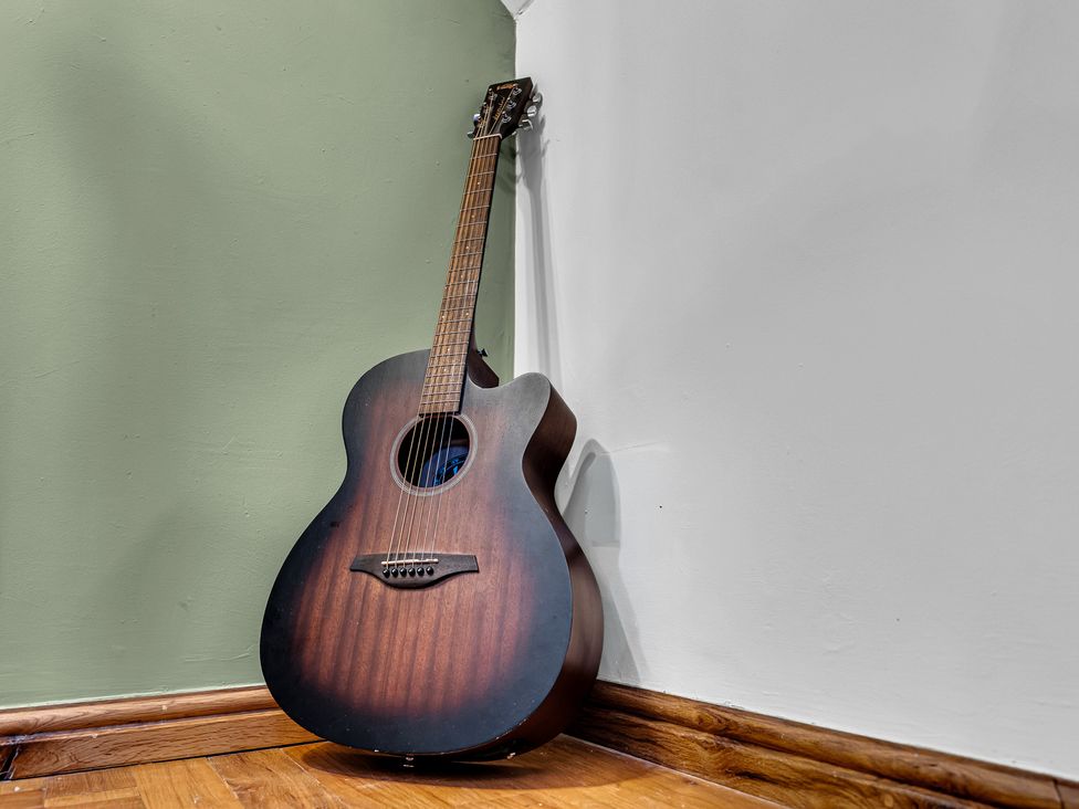 A guitar leaning against the wall at Oxhay Barn Newcastle