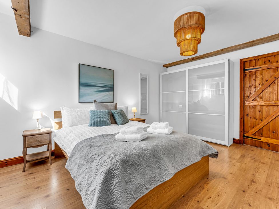 A bedroom with a bed and nightstand at Oxhay Barn Newcastle