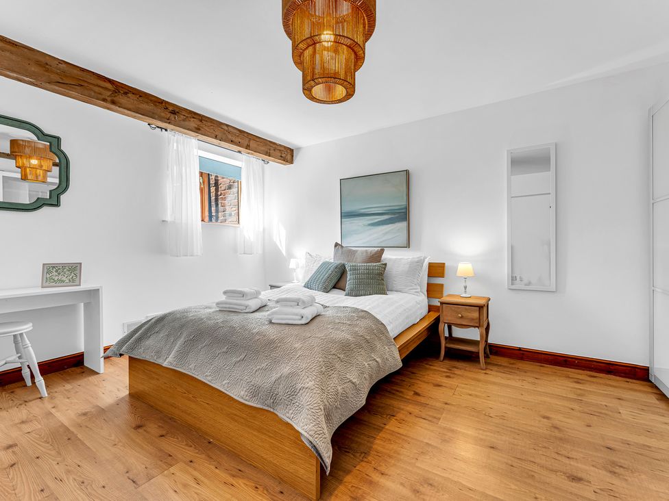 A bedroom with a bed and a lamp at Oxhay Barn in Newcastle
