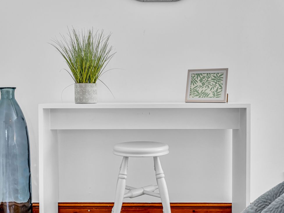A table with a plant and photo frame at Oxhay Barn Newcastle