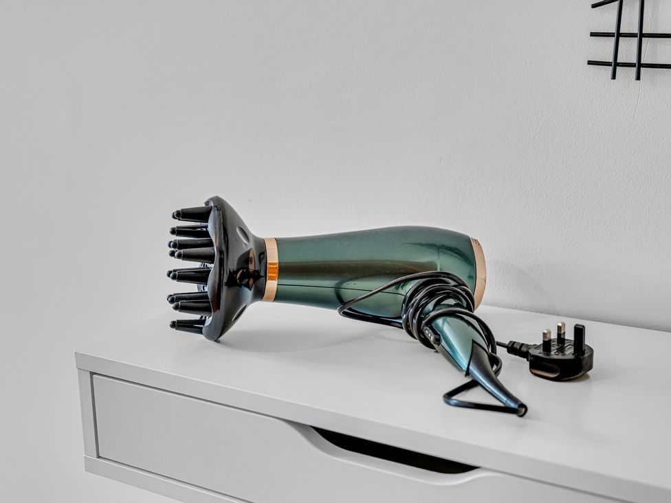 A hair dryer on a shelf at Oxhay Barn Newcastle