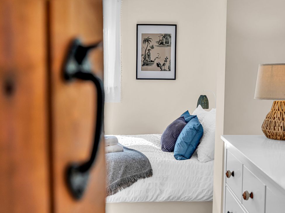 A bedroom with a bed and lamp at Oxhay Barn in Newcastle