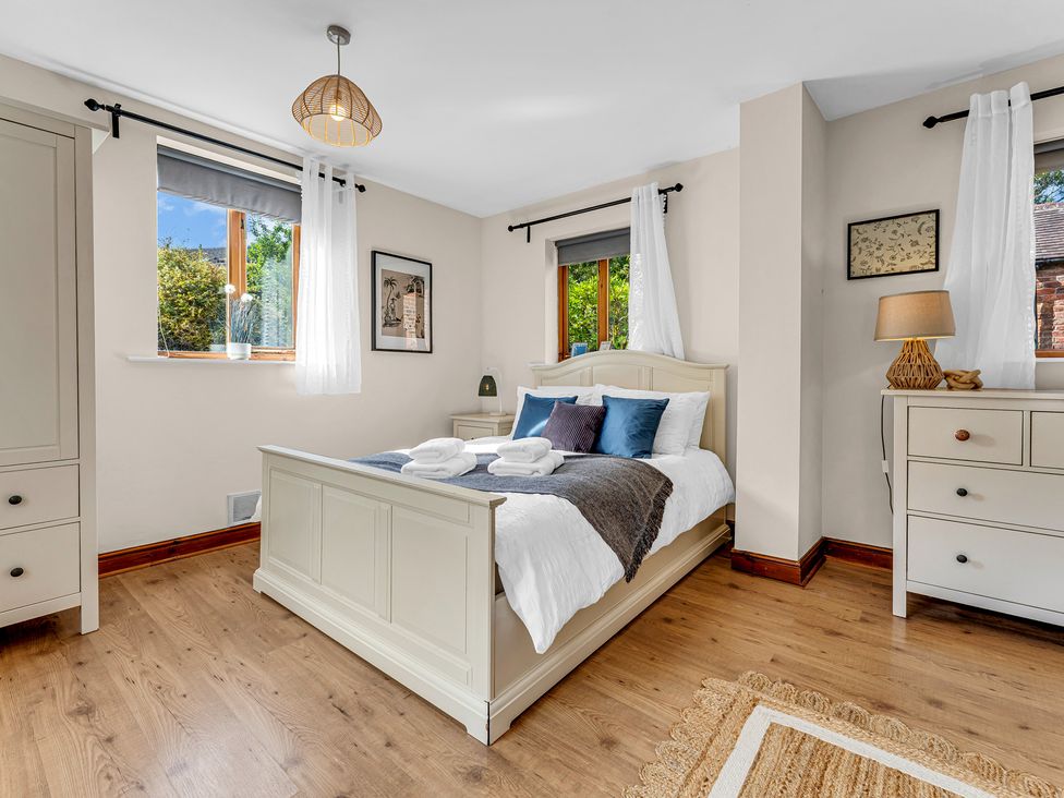A bedroom with a bed and dresser at Oxhay Barn Newcastle