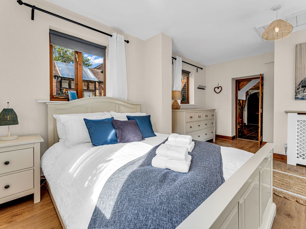 A bedroom with a bed and dresser at Oxhay Barn in Newcastle