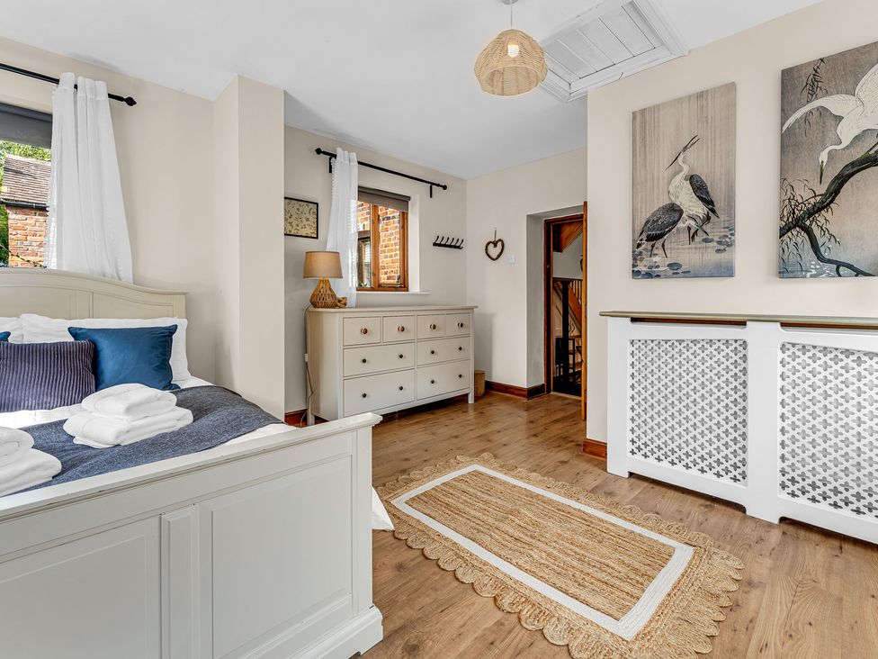 A bedroom with a bed and dresser at Oxhay Barn Newcastle
