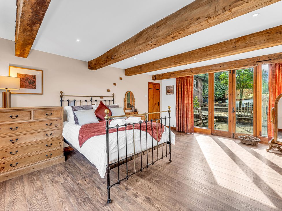 A bedroom with a bed and dresser at Oxhay Barn Newcastle