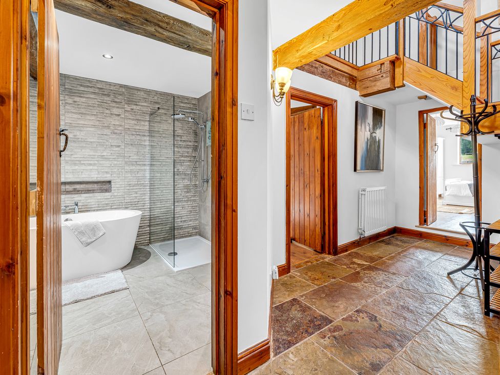 A bathroom featuring a bathtub and shower at Oxhay Barn Newcastle