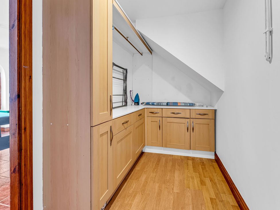 A utility room with cabinets and an iron at Oxhay Barn Newcastle