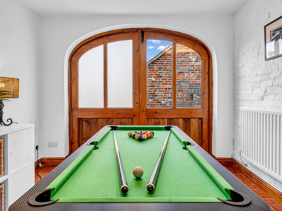 A game room with a pool table and wooden door at Oxhay Barn Newcastle