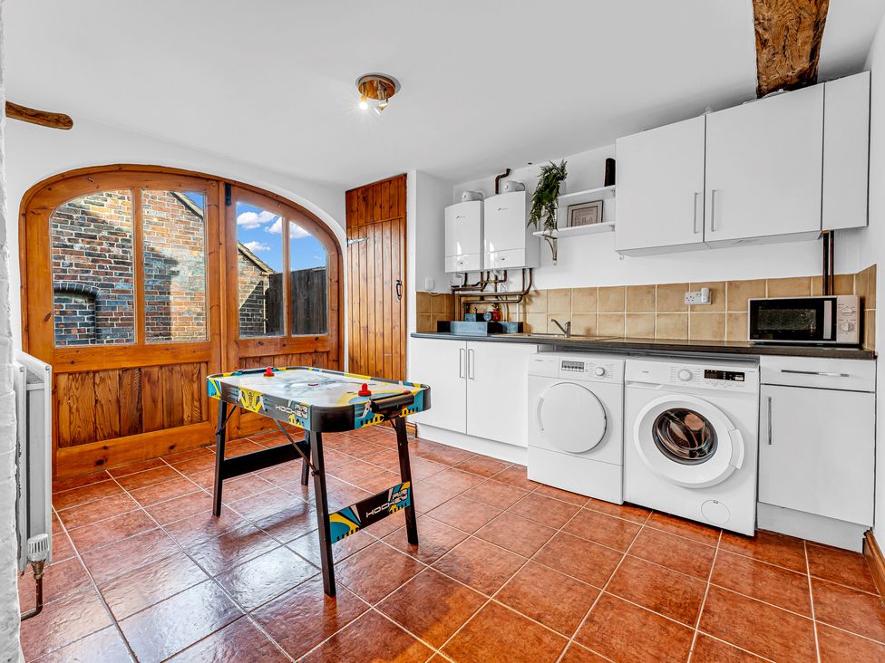 A kitchen with an air hockey table and appliances at Oxhay Barn Newcastle