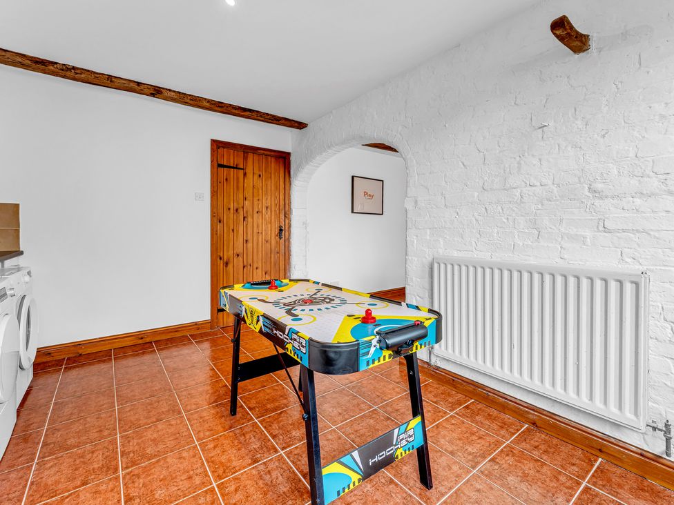 A game room with an air hockey table at Oxhay Barn in Newcastle