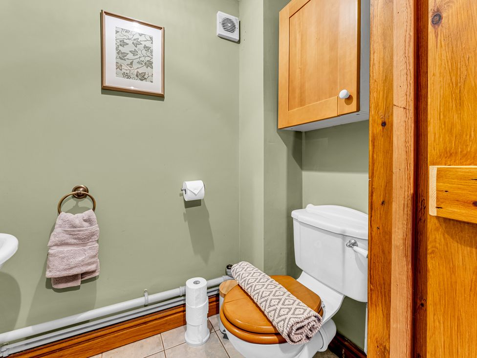 A bathroom with a toilet and a towel holder at Oxhay Barn Newcastle