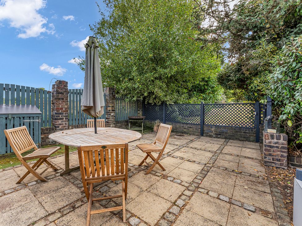 A garden with a table and chairs at Oxhay Barn Newcastle