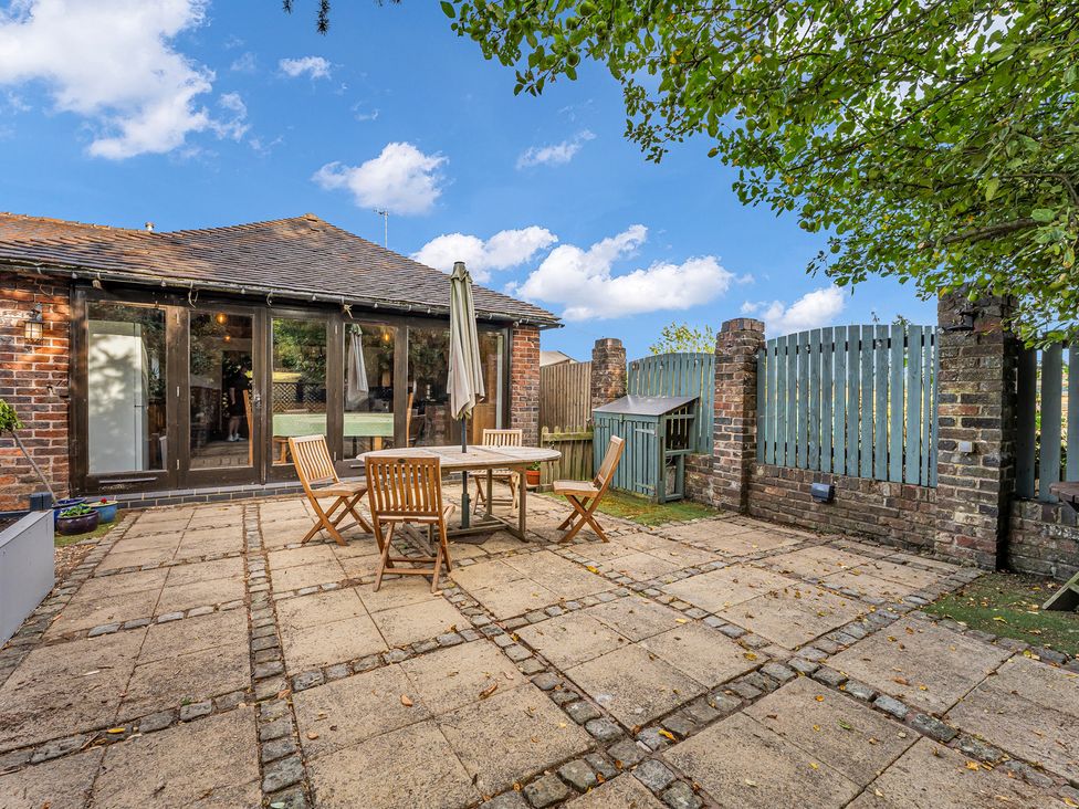 A garden with a table and chairs at Oxhay Barn Newcastle