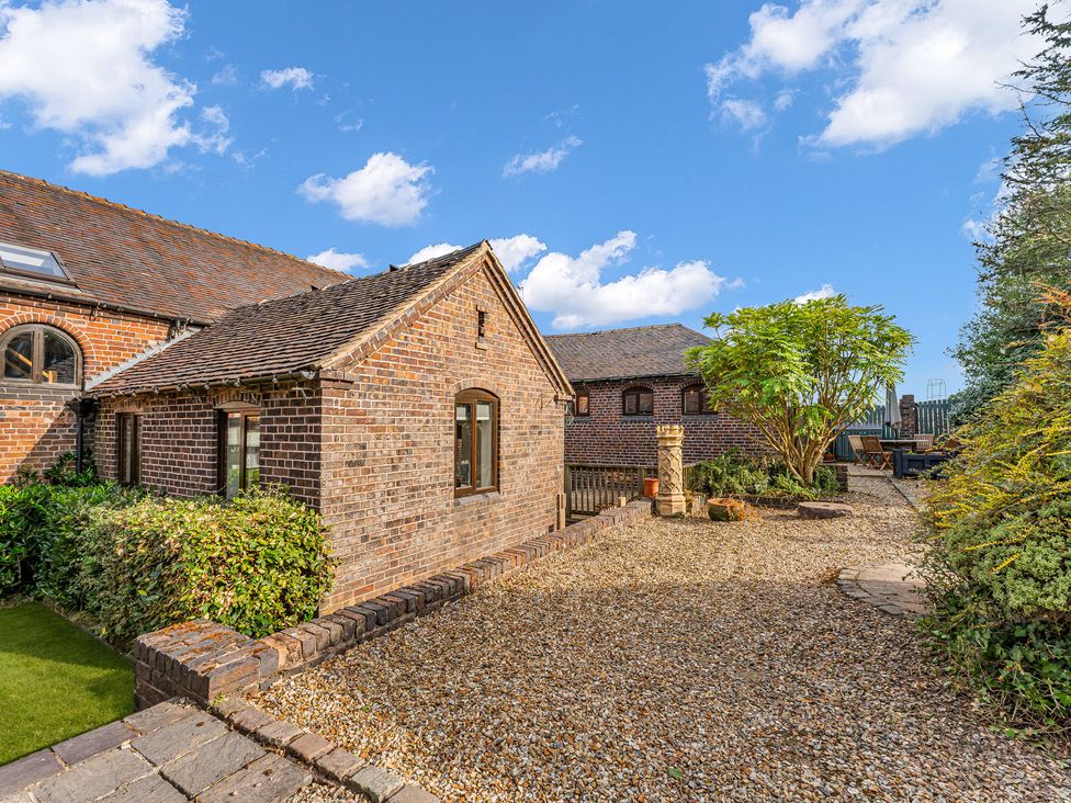A garden with brick walls and plants at Oxhay Barn in Newcastle