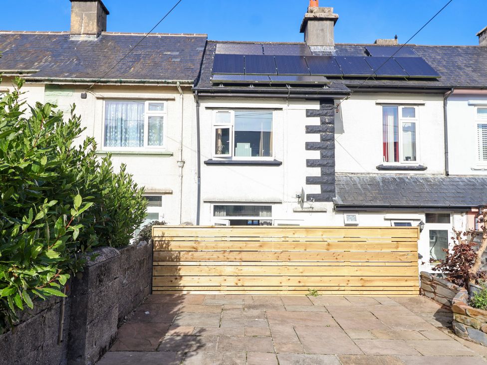 An outdoor area with a wooden fence and patio at Angels Place in Yelverton