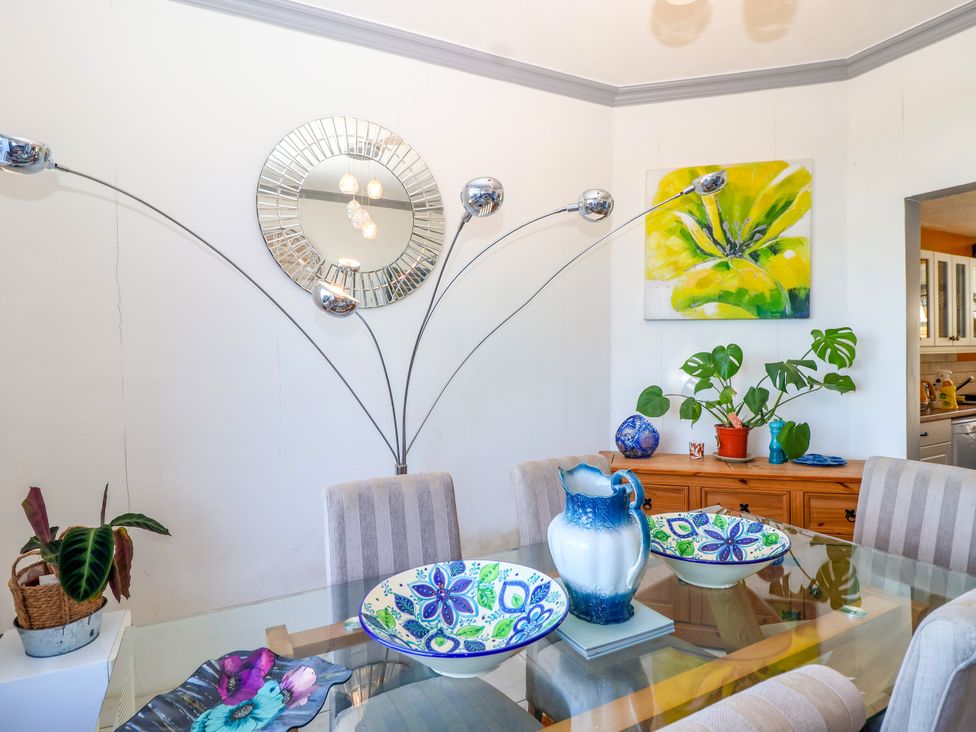 A dining room with a table and chairs at Angels Place in Yelverton