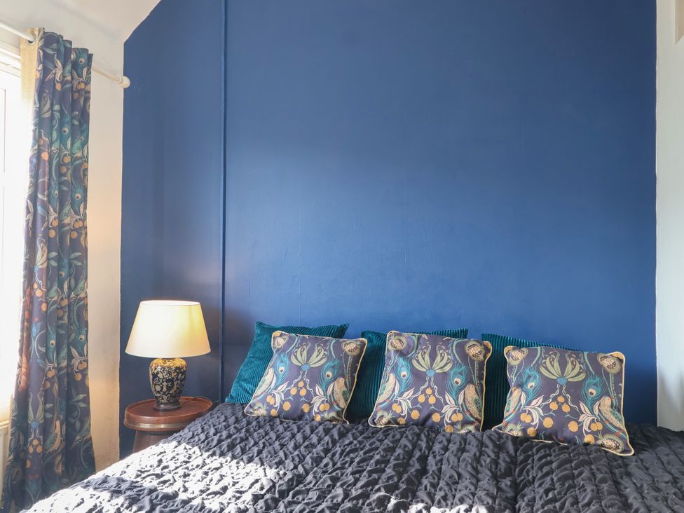 A bedroom with a bed and lamp at Angels Place in Yelverton