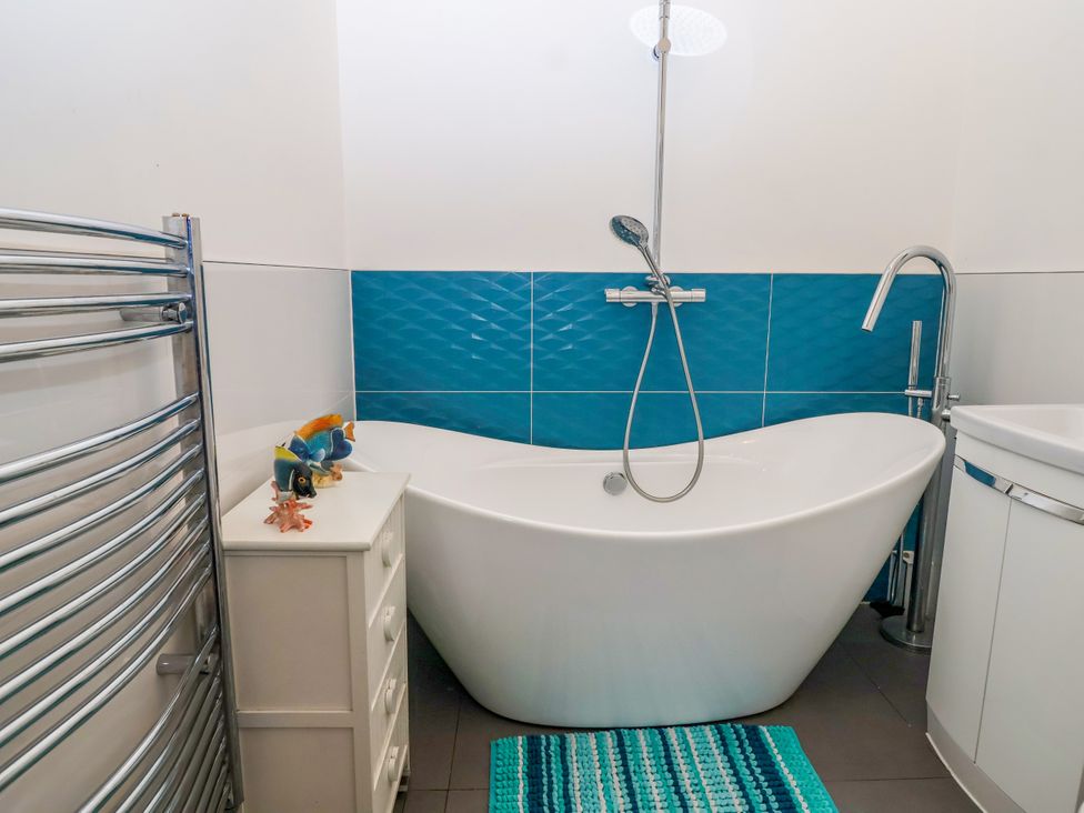 A bathroom with a bathtub and sink at Angels Place in Yelverton