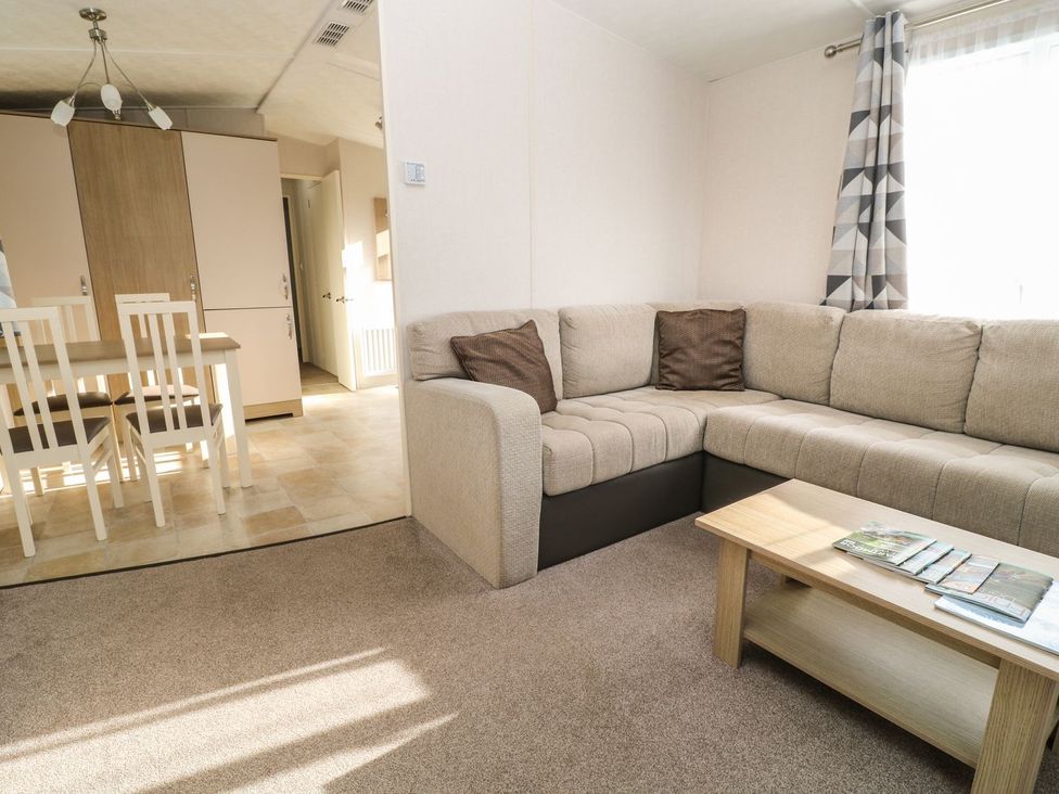 A living room with a sofa and dining table at Feather Tor in Tavistock