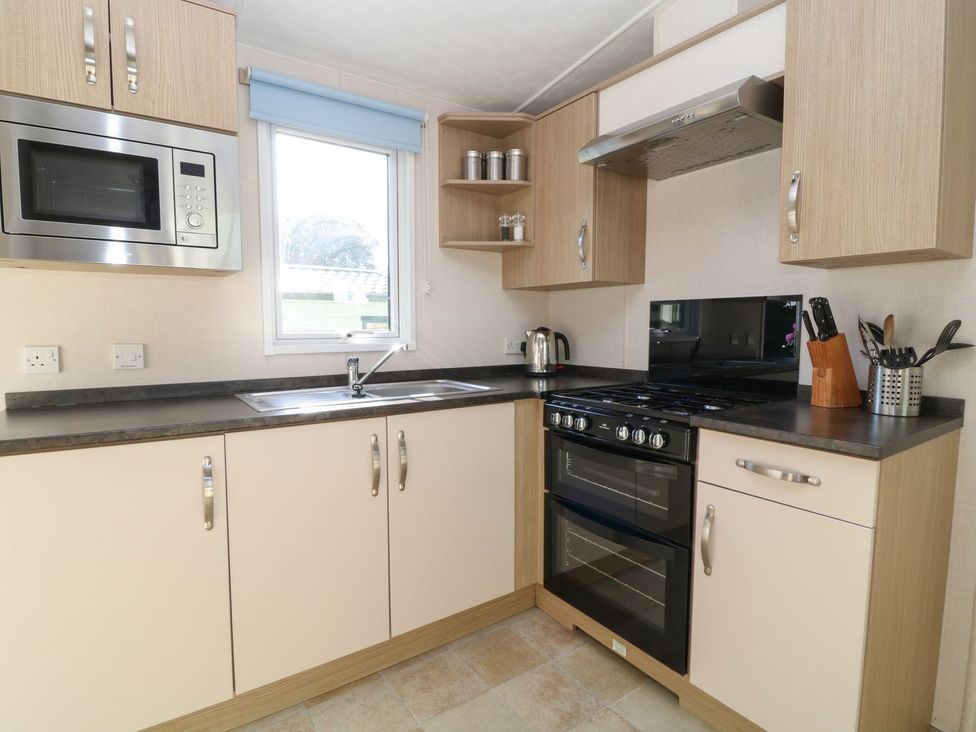 A kitchen with a sink and stove at Feather Tor in Tavistock