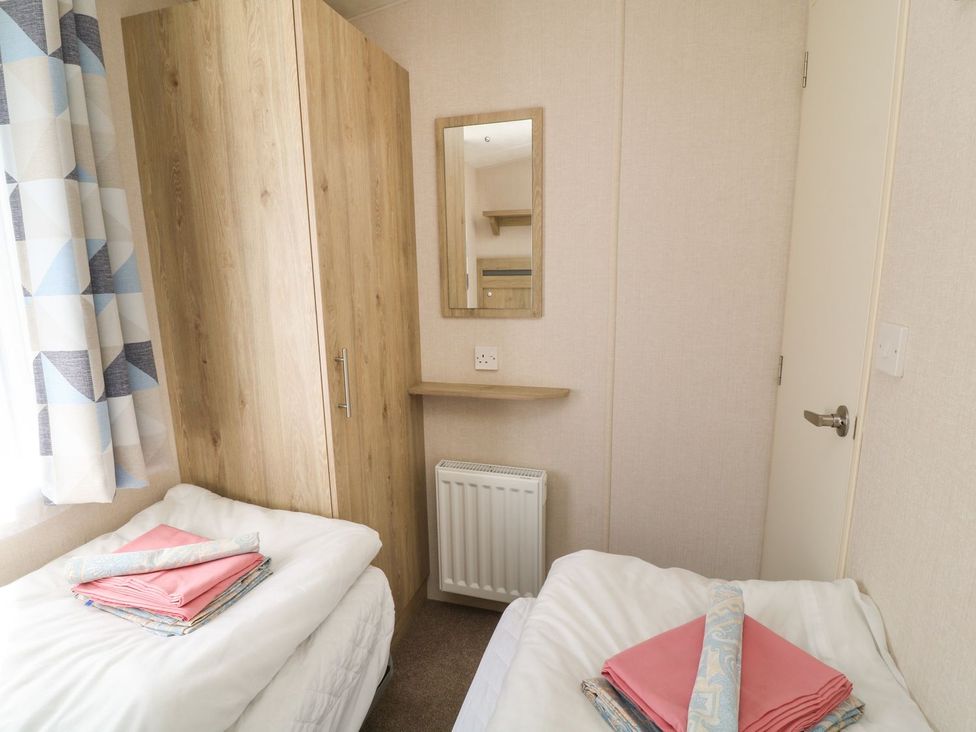A bedroom with beds and wardrobe at Feather Tor in Tavistock