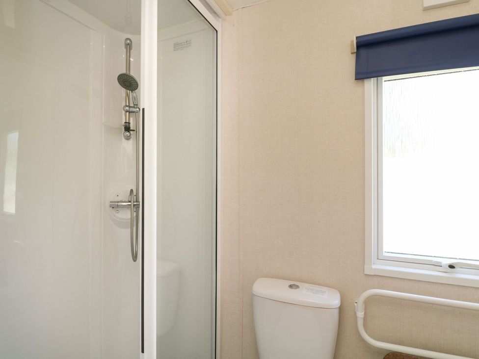 A bathroom with a shower and toilet at Feather Tor in Tavistock