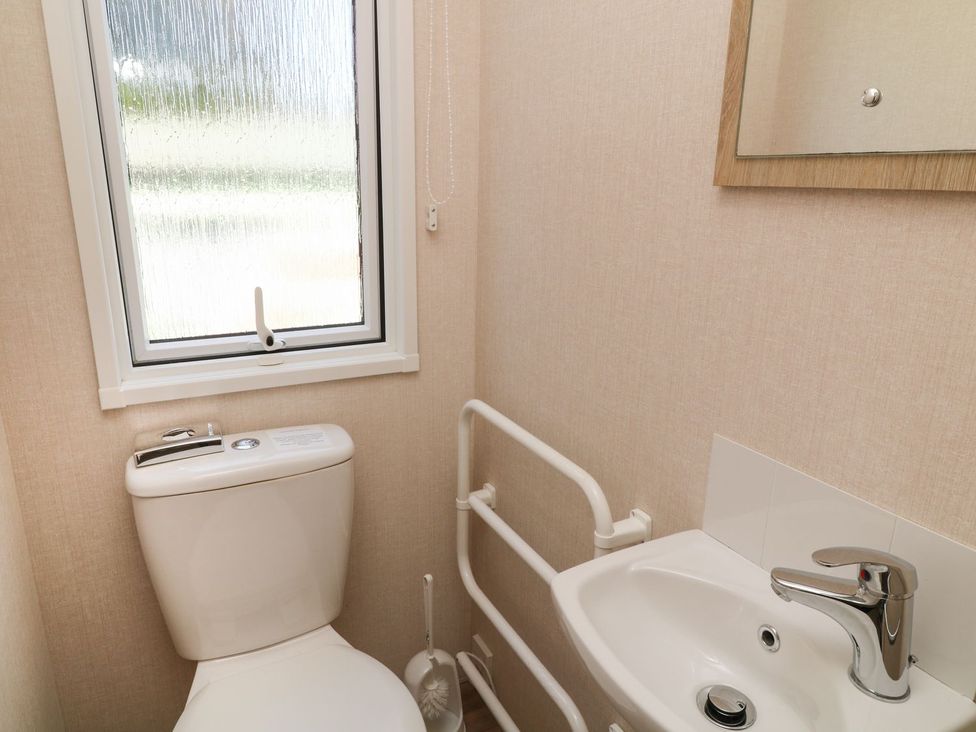 A bathroom with a toilet and sink at Feather Tor in Tavistock