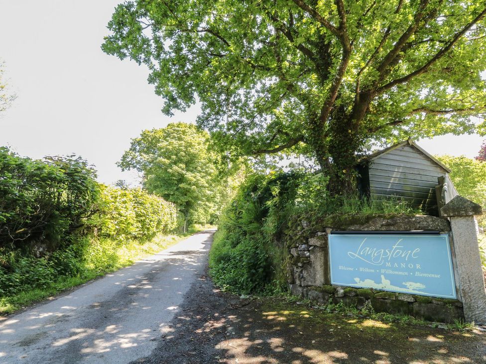 A sign at the entrance of Langstone Manor on a road in Tavistock