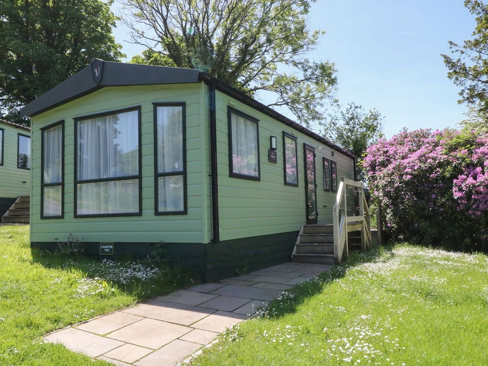A mobile home with steps and flowers at Laughter Tor Tavistock