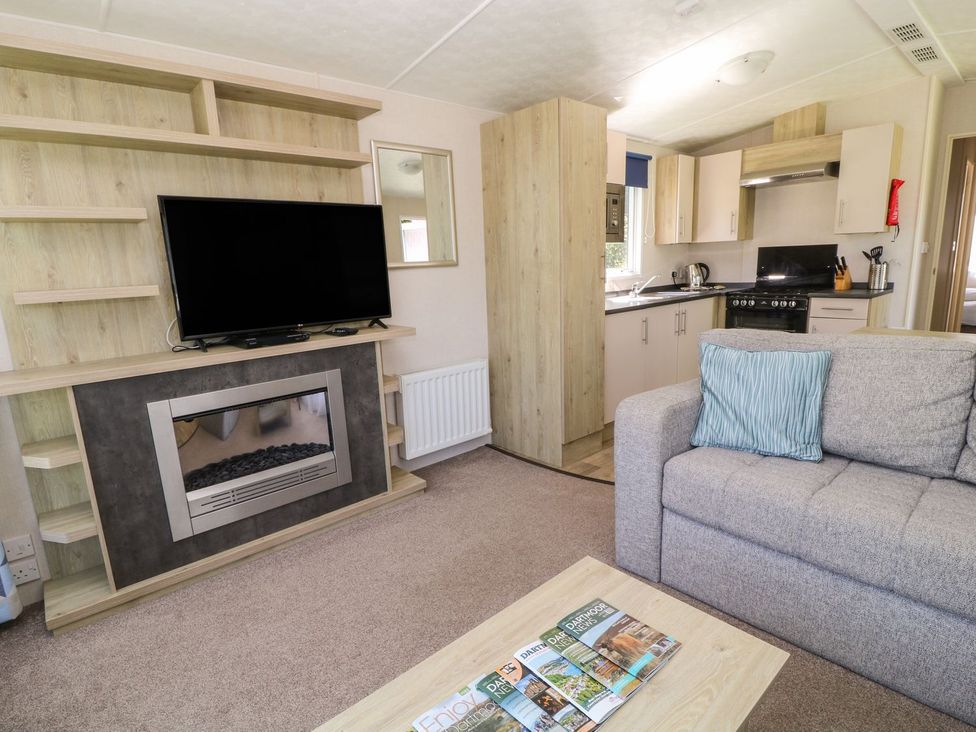 A living room with a couch and television at Laughter Tor in Tavistock